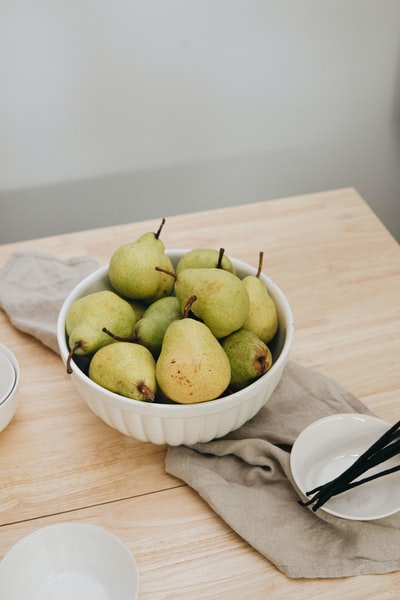 green apple fruit on white ceramic bowl